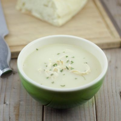 Avgolemono soup being prepared with eggs and lemon juice in a glass bowl